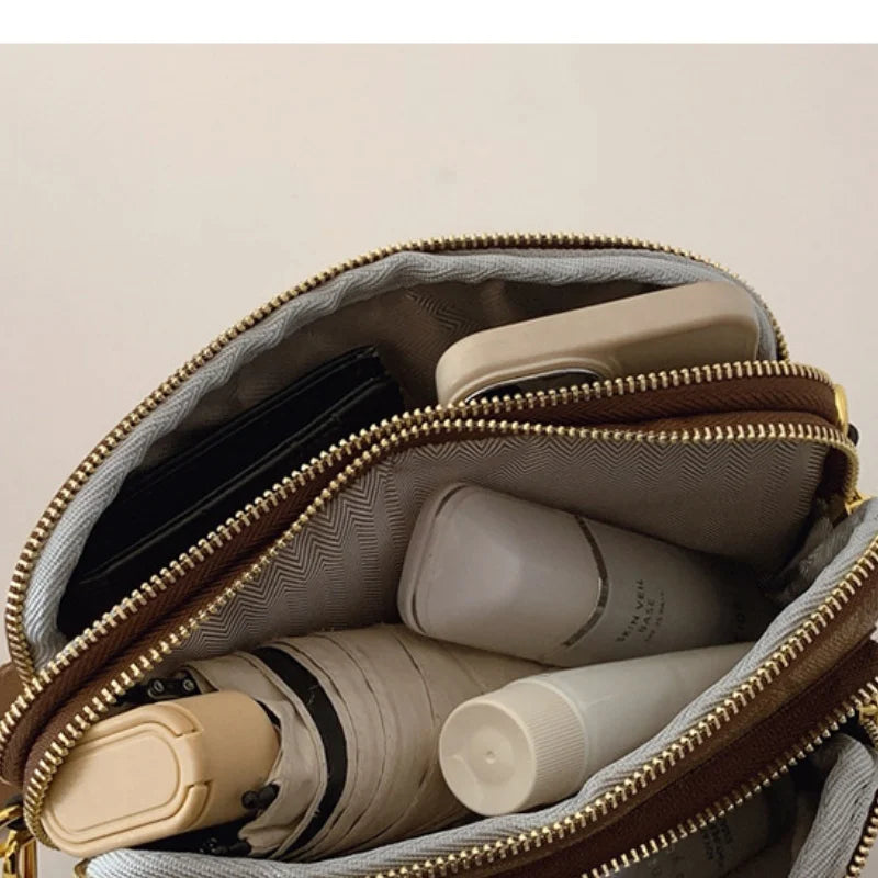 Original Circular-Pattern Logo Crossbody: Retro-luxury, durable fabric, adjustable strap. Ideal for daily/work/social use
